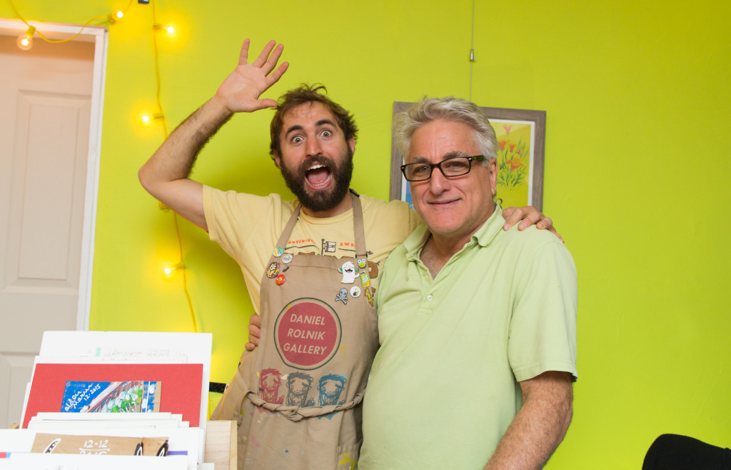 Owner Daniel Rolnick celebrates his gallery opening with his father, right.